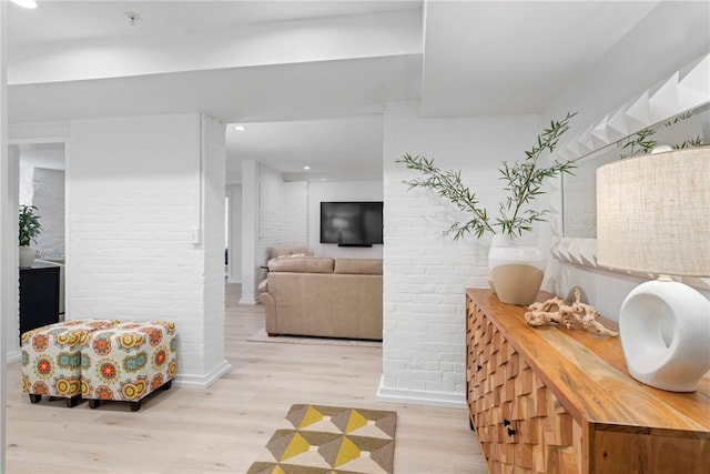 426 Spring St Unit B101, Newport, RI 02840 - living area featuring wood finished floors, brick wall, baseboards, and recessed lighting