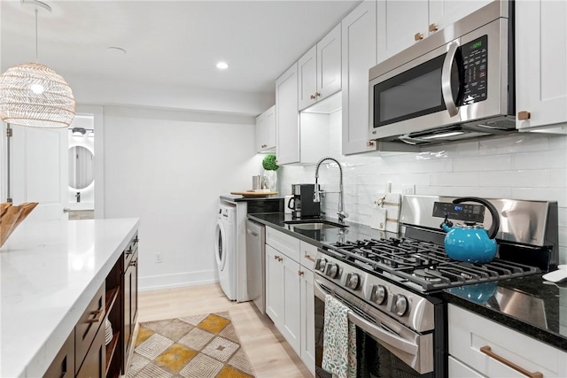 426 Spring St Unit B101, Newport, RI 02840 - kitchen with stainless steel appliances, a sink, backsplash, white cabinets, and recessed lighting