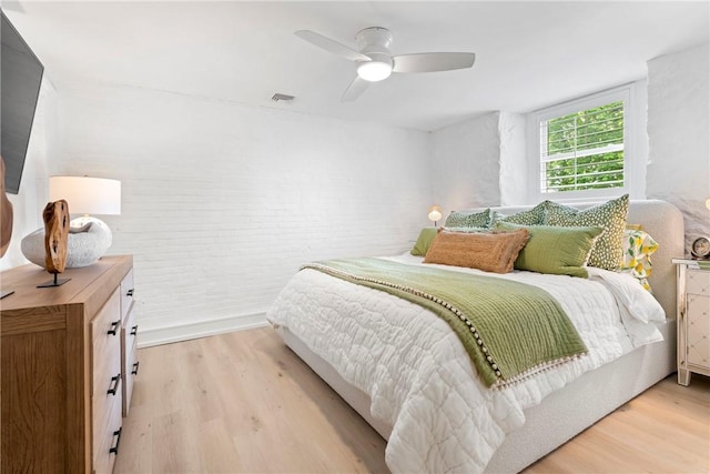 426 Spring St Unit B101, Newport, RI 02840 - bedroom featuring light wood-style flooring, brick wall, and ceiling fan