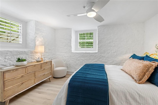 426 Spring St Unit B101, Newport, RI 02840 - bedroom with light wood-style floors, a textured wall, and ceiling fan