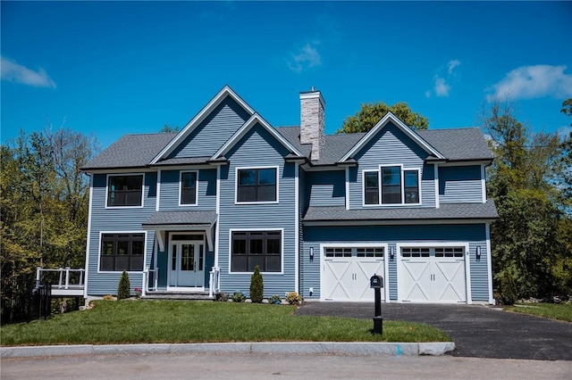 9 Chase Ln, Lincoln, RI 02865 - view of front of property with a chimney, driveway, a garage, and a front yard