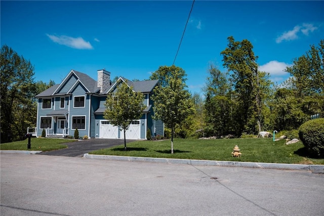 9 Chase Ln, Lincoln, RI 02865 - view of front of property featuring an attached garage, driveway, a chimney, and a front yard