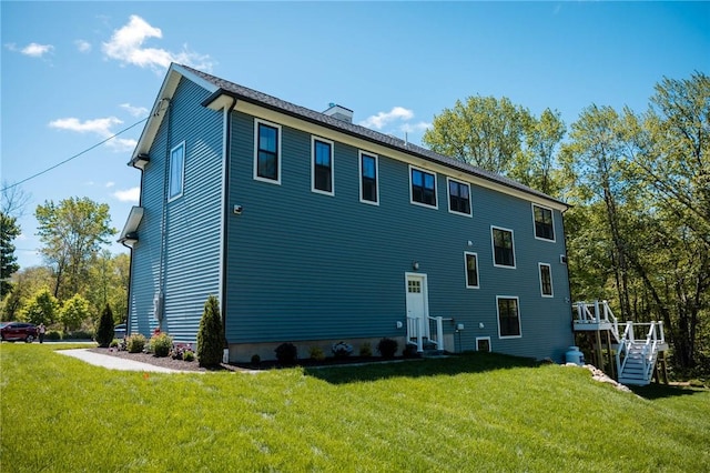 9 Chase Ln, Lincoln, RI 02865 - view of property exterior with a yard, a chimney, a wooden deck, and stairway