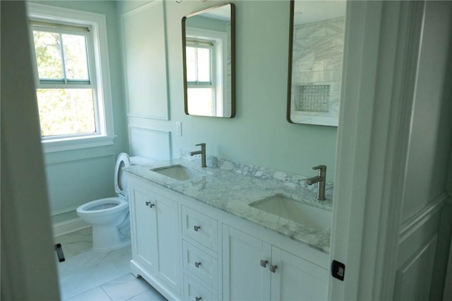 9 Chase Ln, Lincoln, RI 02865 - full bath featuring double vanity, toilet, healthy amount of natural light, and marble finish floors