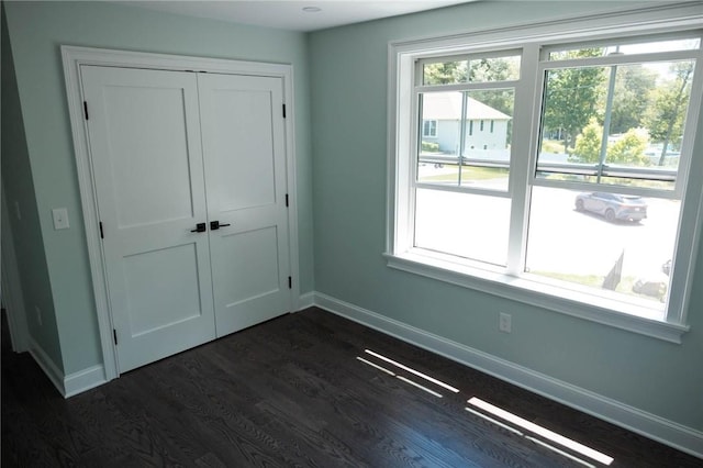 9 Chase Ln, Lincoln, RI 02865 - unfurnished bedroom with dark wood finished floors, baseboards, and a closet