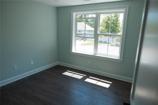 9 Chase Ln, Lincoln, RI 02865 - empty room with plenty of natural light, dark wood-style floors, and baseboards
