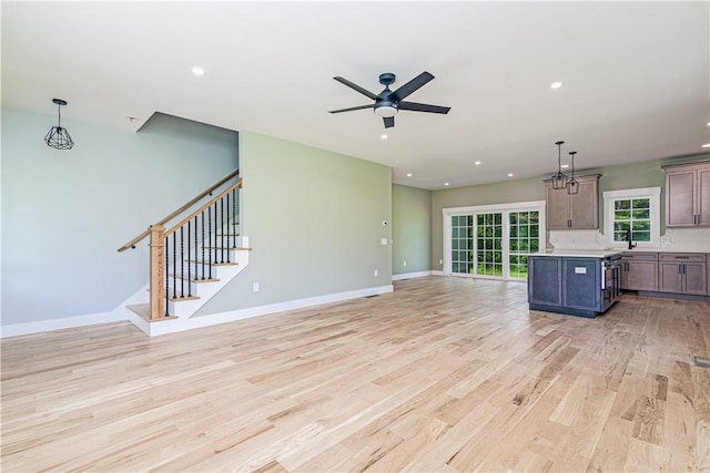 125 Fairview Ave, Hopkinton, RI 02832 - unfurnished living room featuring light wood-style floors, ceiling fan, stairs, and recessed lighting