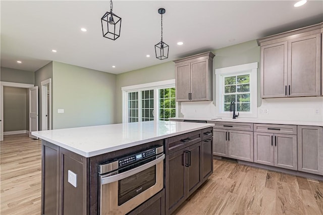 125 Fairview Ave, Hopkinton, RI 02832 - kitchen featuring light wood-style flooring, recessed lighting, light countertops, pendant lighting, and a kitchen island