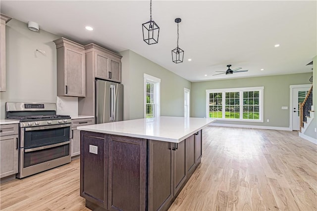 125 Fairview Ave, Hopkinton, RI 02832 - kitchen featuring appliances with stainless steel finishes, open floor plan, light wood finished floors, ceiling fan, and light countertops