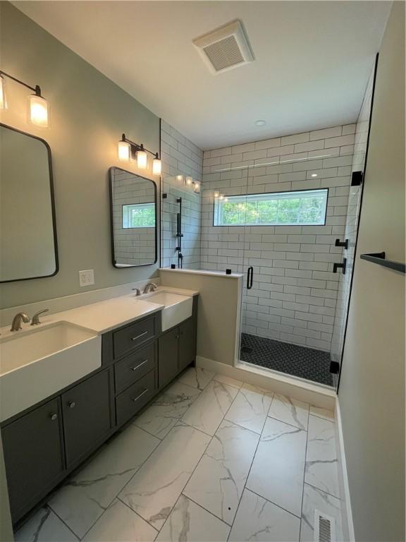 125 Fairview Ave, Hopkinton, RI 02832 - bathroom with marble look tiles, double vanity, and a shower stall