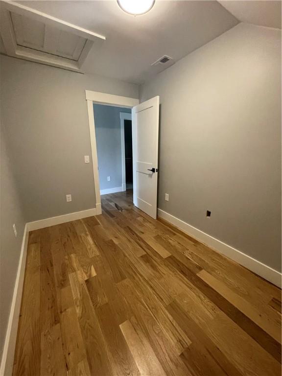 125 Fairview Ave, Hopkinton, RI 02832 - unfurnished room with wood finished floors and attic access