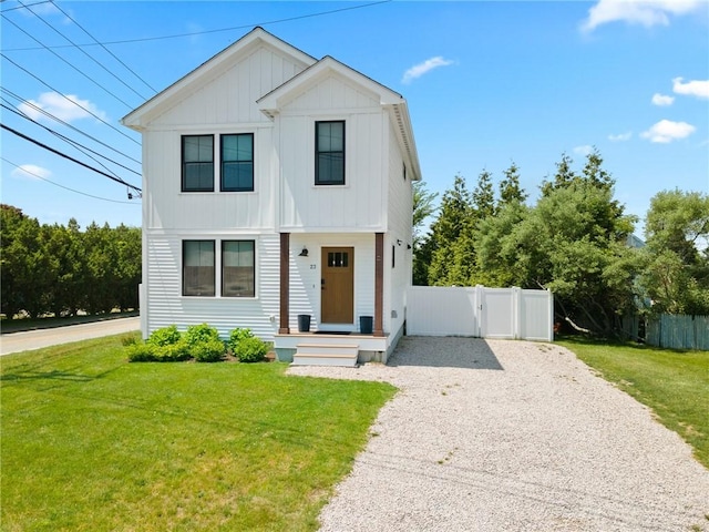 23 Hemlock St, Narragansett, RI 02882 - view of front of house with gravel driveway, board and batten siding, and a gate