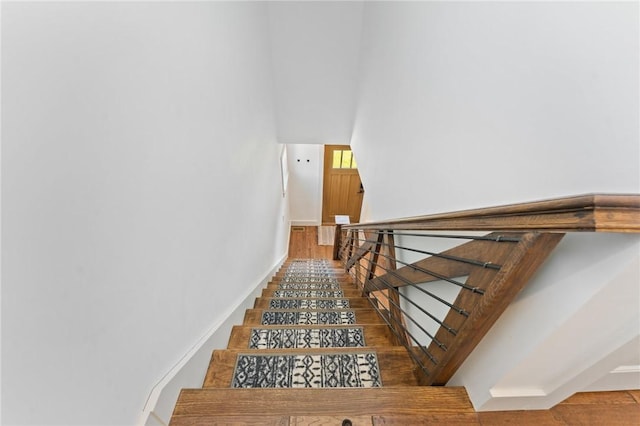 23 Hemlock St, Narragansett, RI 02882 - stairway with baseboards, wood finished floors, and a towering ceiling