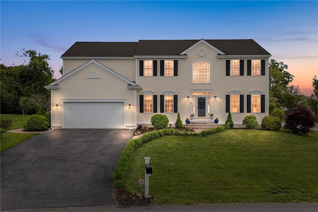 68 Anchor Dr, Portsmouth, RI 02871 - colonial home with driveway, a lawn, and a garage