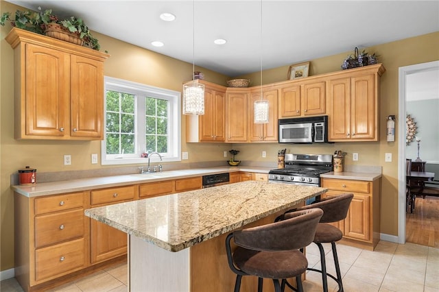 68 Anchor Dr, Portsmouth, RI 02871 - kitchen featuring appliances with stainless steel finishes, a sink, a center island, a kitchen bar, and decorative light fixtures