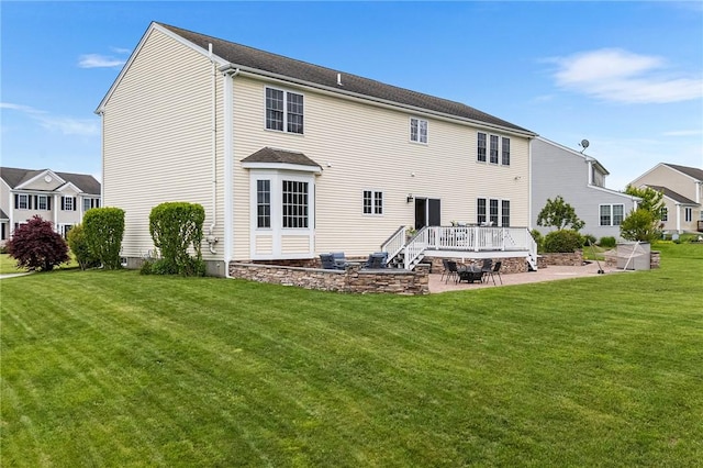68 Anchor Dr, Portsmouth, RI 02871 - rear view of property featuring a patio, a yard, and a wooden deck