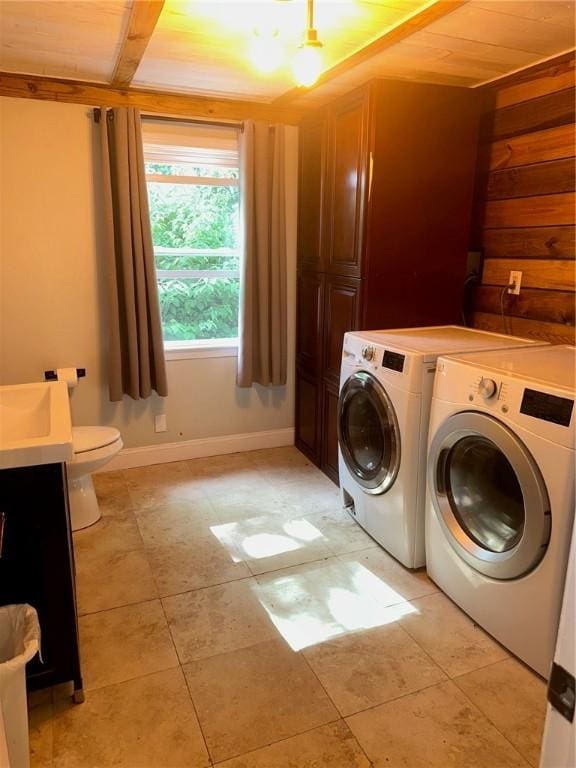 21 Baldwin Rd, Warwick, RI 02886 - laundry area with washer and clothes dryer, baseboards, and light tile patterned flooring