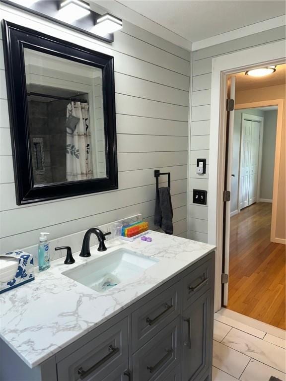 21 Baldwin Rd, Warwick, RI 02886 - full bathroom with vanity, wooden walls, and marble finish floors