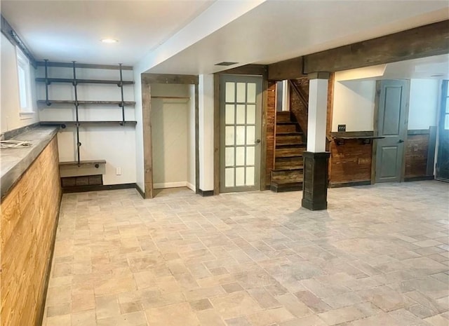 21 Baldwin Rd, Warwick, RI 02886 - below grade area with light stone finish floors, stairs, and baseboards