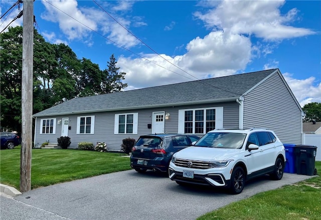 71 Carlton St, Cranston, RI 02910 - view of front of home featuring roof with shingles and a front lawn