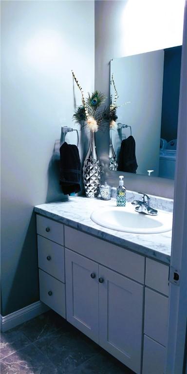 71 Carlton St, Cranston, RI 02910 - bathroom featuring vanity, marble finish flooring, and baseboards