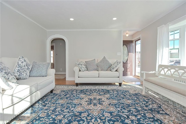 822 Cottage St, Pawtucket, RI 02861 - living area featuring crown molding, arched walkways, wood finished floors, baseboards, and recessed lighting