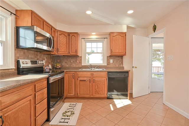 822 Cottage St, Pawtucket, RI 02861 - kitchen with stainless steel appliances, a sink, tasteful backsplash, light tile patterned floors, and recessed lighting