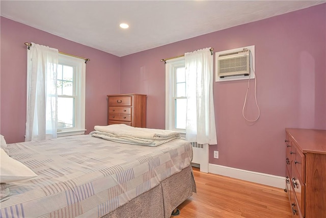 822 Cottage St, Pawtucket, RI 02861 - bedroom featuring radiator, light wood-type flooring, a wall mounted air conditioner, baseboards, and recessed lighting