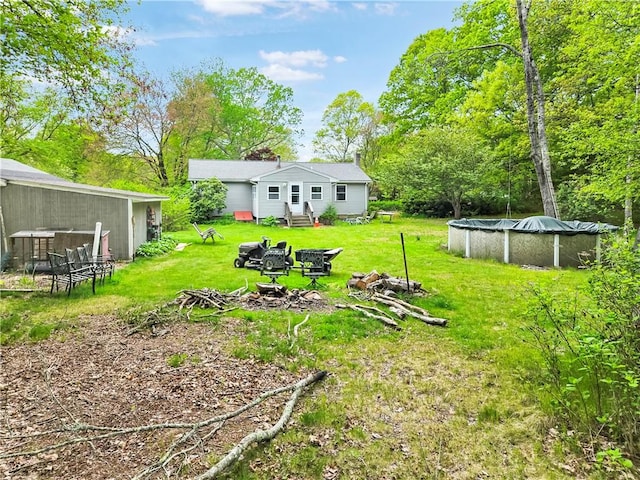 294 Railroad Ave, North Kingstown, RI 02874 - view of grassy yard featuring a covered pool and a fire pit