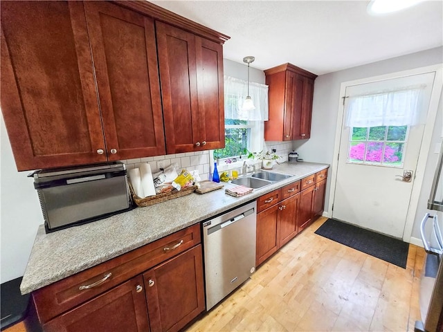 294 Railroad Ave, North Kingstown, RI 02874 - kitchen featuring dishwasher, tasteful backsplash, a sink, light wood-style flooring, and light countertops