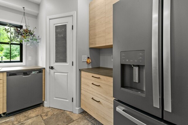 45 Lloyd Bowen Ct, Glocester, RI 02814 - kitchen with stainless steel appliances, stone tile flooring, light brown cabinetry, and dark countertops