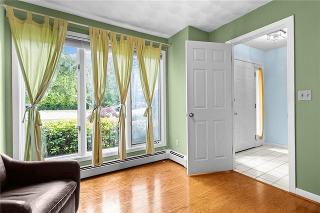 53 Morgan Ct, North Kingstown, RI 02852 - living area featuring a baseboard heating unit and tile patterned floors
