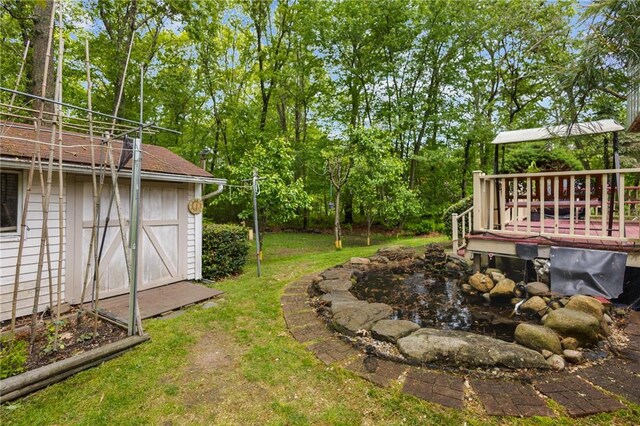 53 Morgan Ct, North Kingstown, RI 02852 - view of green lawn with a wooden deck and view of wooded area