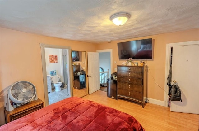 12 Hamilton St, Providence, RI 02907 - bedroom with wood finished floors, baseboards, and ensuite bathroom
