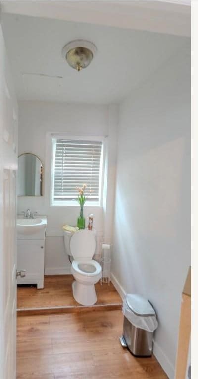 12 Hamilton St, Providence, RI 02907 - bathroom with toilet, wood finished floors, vanity, and baseboards