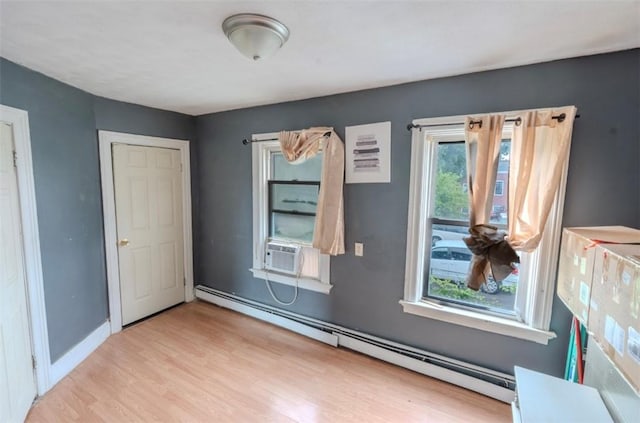 12 Hamilton St, Providence, RI 02907 - empty room featuring baseboard heating, wood finished floors, cooling unit, and baseboards