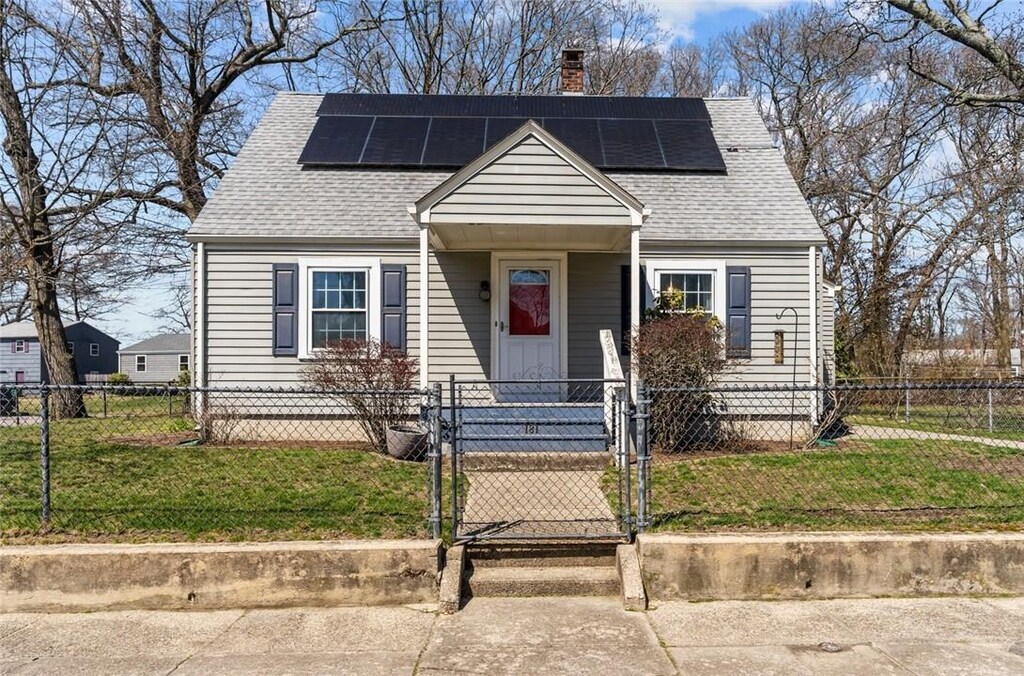 181 Vera St, Warwick, RI 02886 - view of front facade with a gate, a chimney, roof with shingles, and roof mounted solar panels