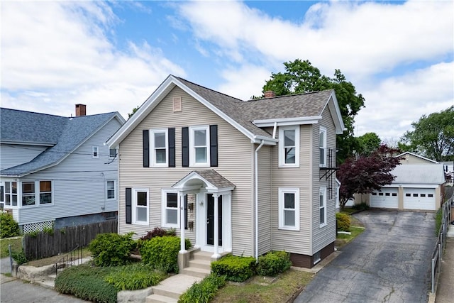 130 Hunts Ave, Pawtucket, RI 02861 - traditional-style house featuring a detached garage, an outdoor structure, a shingled roof, and a chimney
