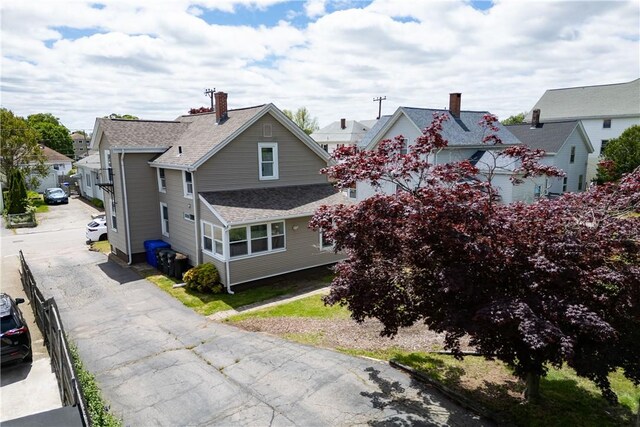 130 Hunts Ave, Pawtucket, RI 02861 - view of front of house with driveway, roof with shingles, and a residential view
