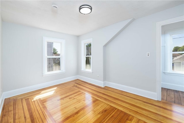 130 Hunts Ave, Pawtucket, RI 02861 - unfurnished room featuring healthy amount of natural light, baseboards, and hardwood / wood-style flooring