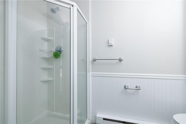 130 Hunts Ave, Pawtucket, RI 02861 - bathroom with a stall shower, a wainscoted wall, a baseboard radiator, and toilet