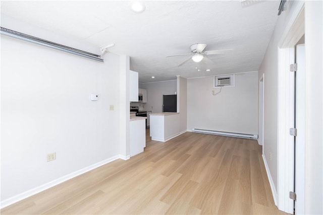 130 Hunts Ave, Pawtucket, RI 02861 - empty room featuring baseboard heating, a wall mounted air conditioner, ceiling fan, light wood-style floors, and baseboards