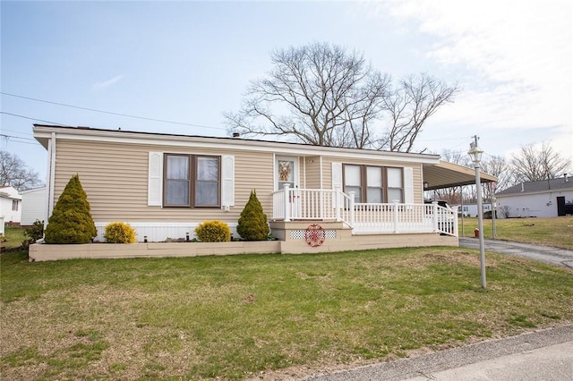 7 Lane D Dr, Coventry, RI 02816 - manufactured / mobile home featuring asphalt driveway, an attached carport, a front lawn, and covered porch