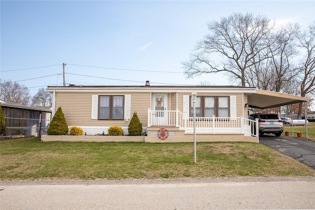 7 Lane D Dr, Coventry, RI 02816 - manufactured / mobile home featuring asphalt driveway, a front yard, and a carport