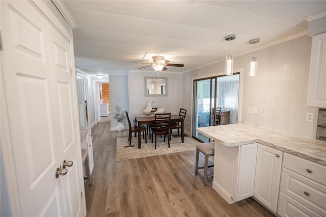 7 Lane D Dr, Coventry, RI 02816 - dining room with light wood finished floors, crown molding, and a ceiling fan