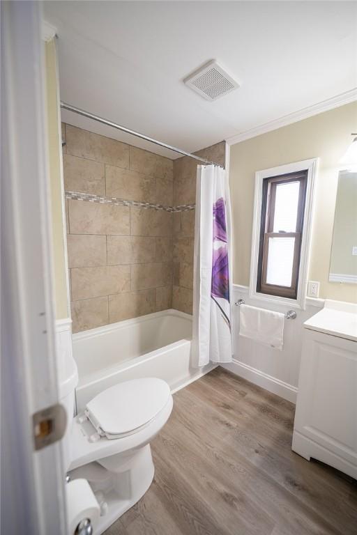 7 Lane D Dr, Coventry, RI 02816 - bathroom featuring vanity, shower / bath combination with curtain, toilet, and wood finished floors