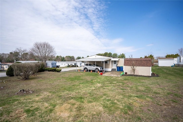 7 Lane D Dr, Coventry, RI 02816 - view of green lawn with a carport and an outbuilding