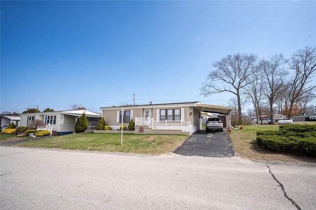 7 Lane D Dr, Coventry, RI 02816 - manufactured / mobile home with asphalt driveway, a front yard, and a carport