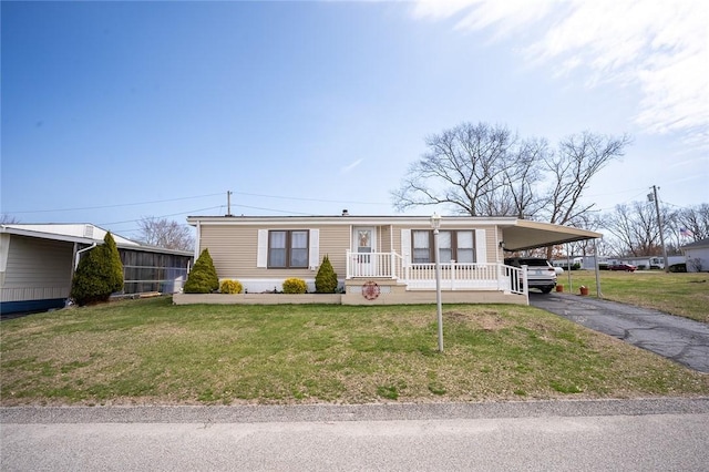 7 Lane D Dr, Coventry, RI 02816 - manufactured / mobile home featuring asphalt driveway, a front yard, and a carport