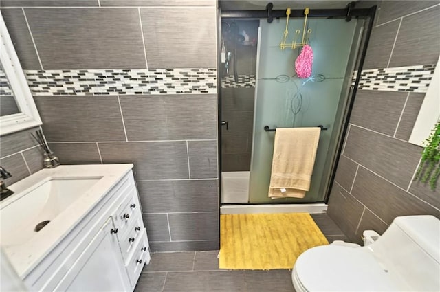 848 Dexter St, Central Falls, RI 02863 - full bath featuring tile walls, vanity, toilet, a shower stall, and tile patterned flooring